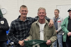 Pete Ryan of Ryan Signs handing jersey to son Rory Ryan