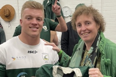 Susan Walton Optometrist handing jersey to Ryan Goodman