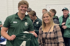 Nicole Elliot of Core Project Group handing jersey to Zac Norgard